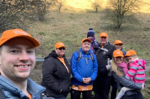 Christine and husband Keith Lockton and Family wearing orange My Marsden March caps in the countryside 