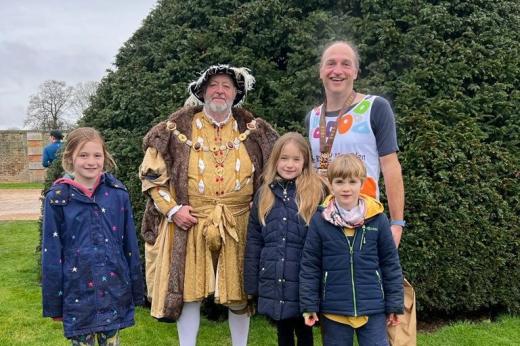Team Marsden runner and his three children posing with Henry VIII