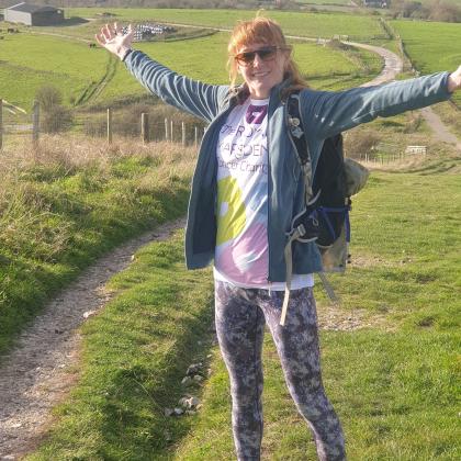 Supporter in Royal Marsden Cancer Charity t-shirt standing on South Downs Way