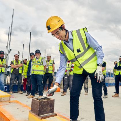 The final block being laid for the construction of The Oak Cancer Centre