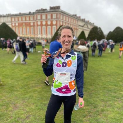 Team Marsden runner Heather, posing with her medal in front of Hampton Court Palace