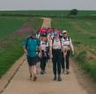 RMCC trekkers hiking across fields with hats on