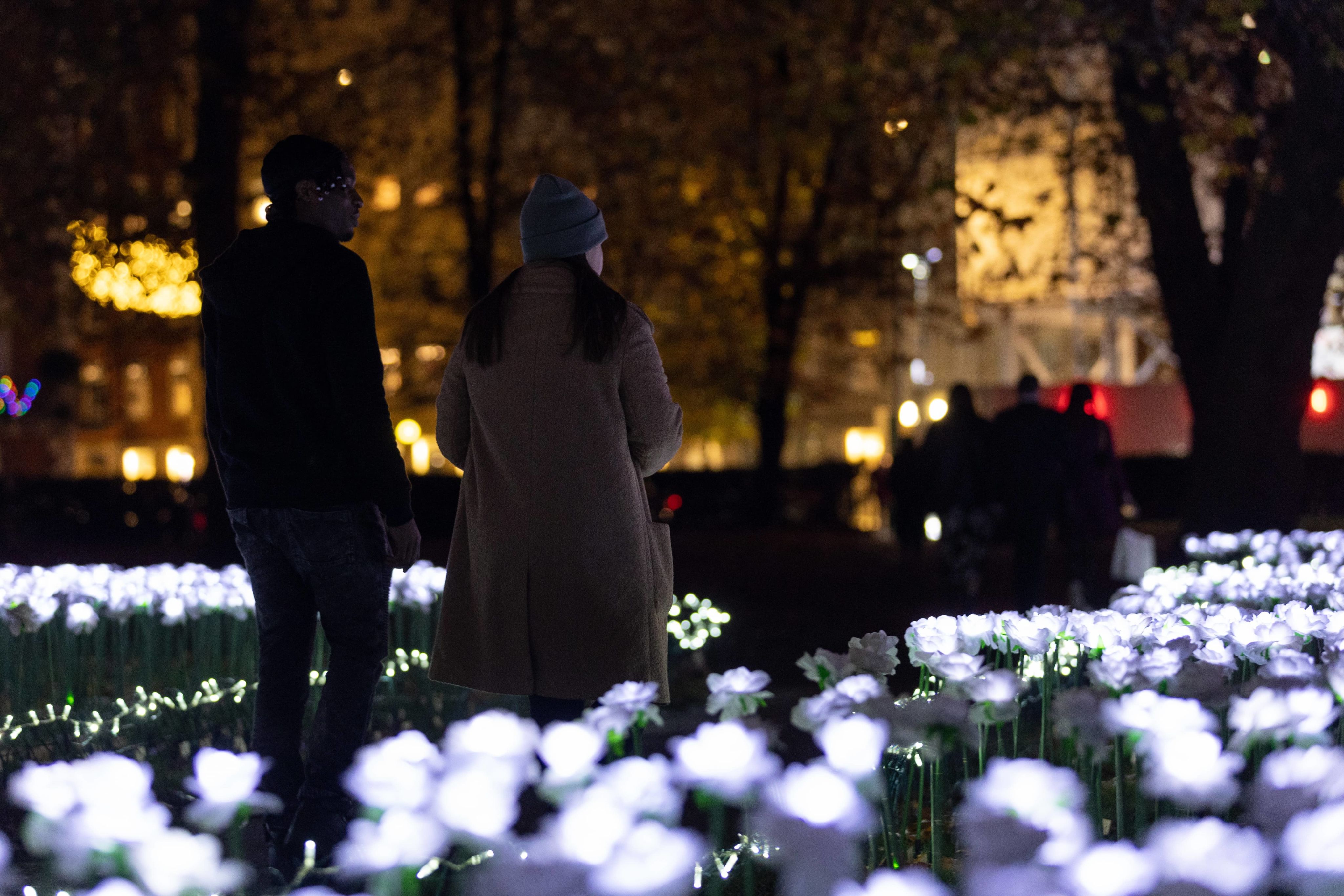 A man and a woman walking together through the Ever After Garden
