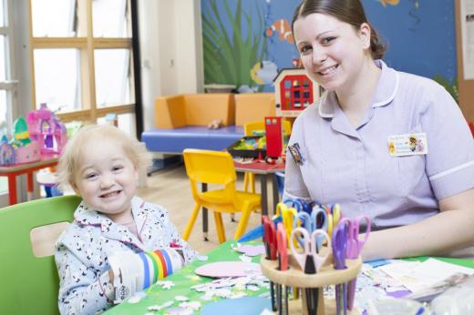 Play specialist Kate Hodgkiss in the playroom with young patient Filly Hookway