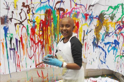 Young patient playing with paint syringes