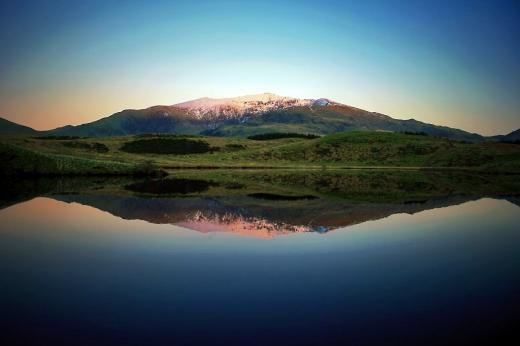 Dawn at Mount Snowdon shown reflected in a lake