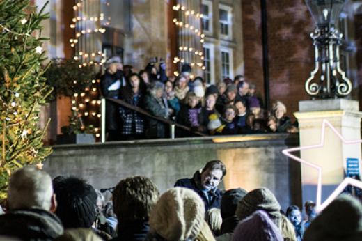 Image of a group of people gathered for a previous carol service