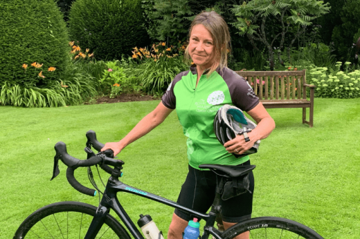 Janet Hanwell in a garden with her bicycle