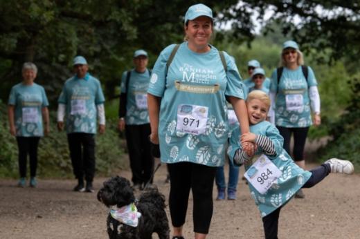 Family and a dog walking in the Banham Marsden March