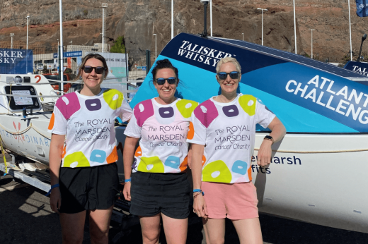 Team ExtraOARdinary with their boat, wearing The Royal Marsden Cancer Charity shirts