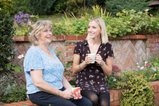 Christine and her daughter Stephanie sat in a garden chatting