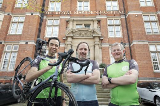  Chief Operating Officer Karl Munslow Ong (left), Chief Financial Officer Marcus Thorman (Centre) and Medical Director Professor Nicholas Van As (right) in front of the Royal Marsden. They are wearing cycling jerseys and Karl is holding a bike. 