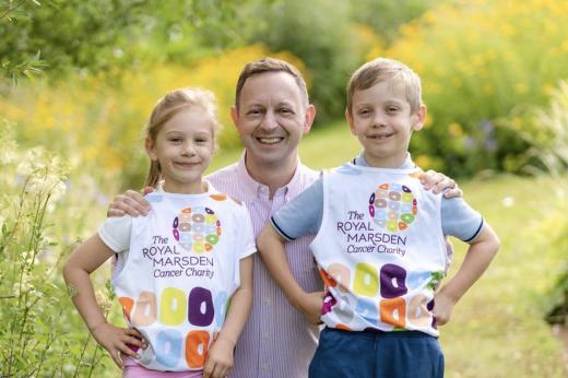 Mark with his arms around Emilie and Reece who are both wearing Royal Marsden Cancer Charity running shirts
