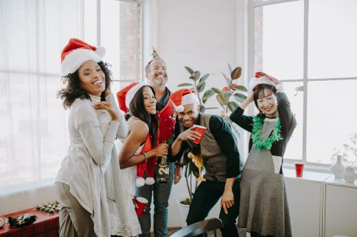 A group of friends wearing Christmas hats having fun