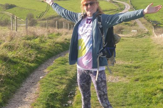 Supporter in Royal Marsden Cancer Charity t-shirt standing on South Downs Way