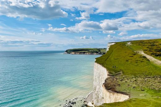 South downs coastal walk. View of blue sea and sky and the edge of the seven sisters cliffs. 