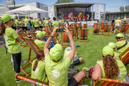 A group of people enjoying the band and dance performances at The Banham Marsden March finish line celebration. 