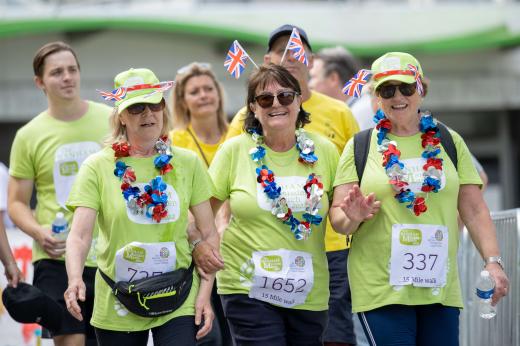A trio of women taking part in the 15 mile march. They are wearing decorations on top of their Banham Marsden March t-shirts.