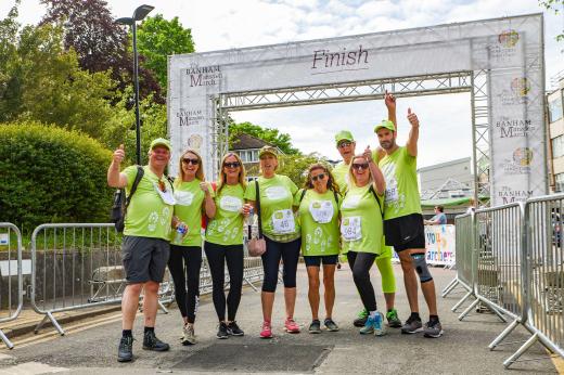 A group of Marchers posing and celebrating at the Finish line in Sutton. 