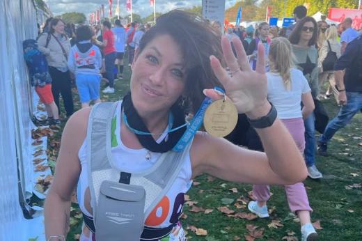 A Team Marsden runner, Claire, shows off her well-deserved Royal Parks Half Marathon 2022 medal