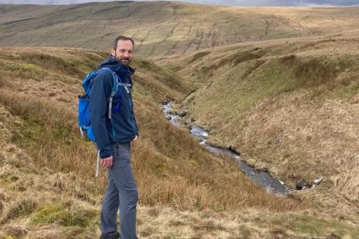 Jon walking across countryside