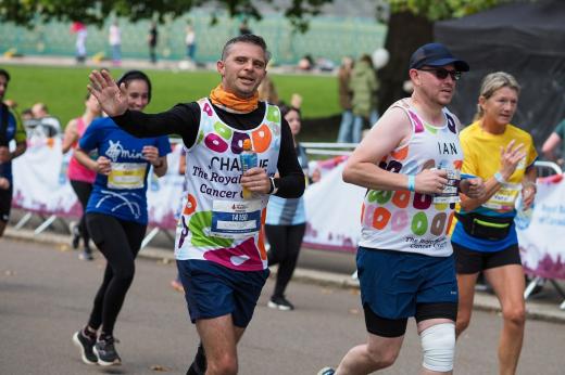 Two Royal Parks 2022 runners, Ian and Charlie, wave at the camera as they go past