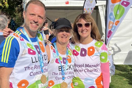 Three Team Marsden runners smile at the charity tent in the Royal Parks Half Marathon 2022 festival village