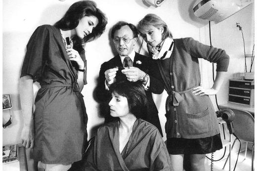 An old black and white photograph showing three people, including a younger Philip Kingsley, working on someone's hair