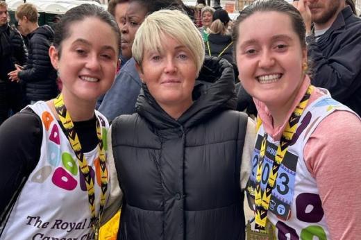 Two Team Marsden runners smile at the camera with their mum after completing the London Landmarks Half Marathon