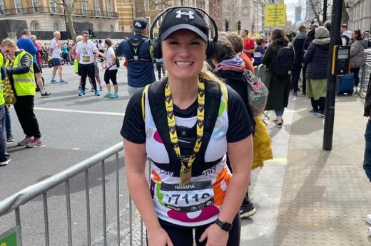 A Team Marsden runner smiles at the camera with her London Landmarks medal