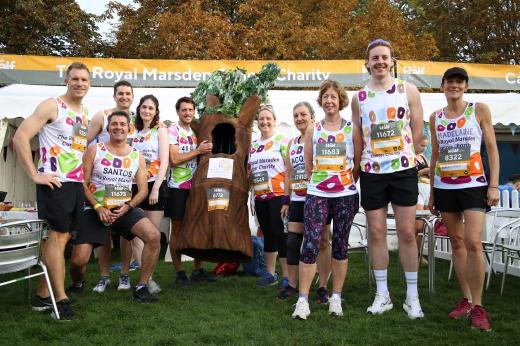 Team Marsden runners for Royal Parks Half Marathon posing in front of a marquee and a tree costume