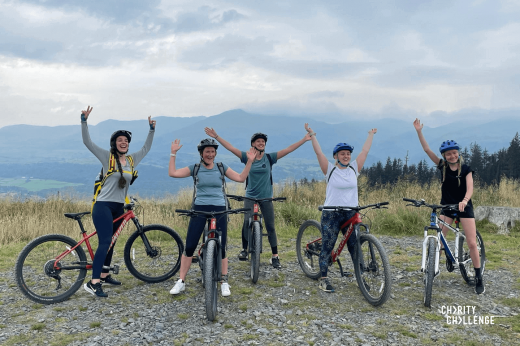 Five cyclists cheer on the Lake District forest trail