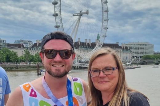 Royal Marsden Runner with his medal in front of the London Eye