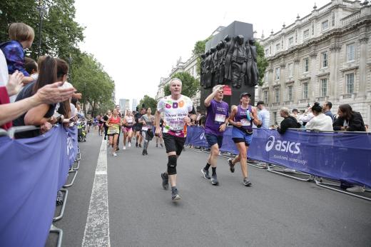 Royal Marsden Supporter runs past the Cenotaph