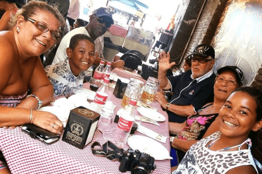 Courtney and her family sat around a table, smiling at the camera