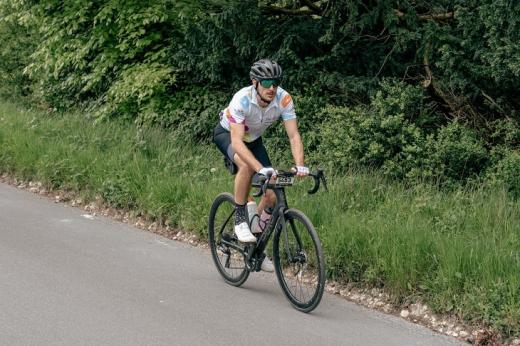 Wes on a bike, cycling down a country road