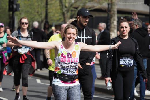 Runner in Royal Marsden Cancer Charity vest with arms out