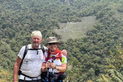 Two hikers in front of mountains