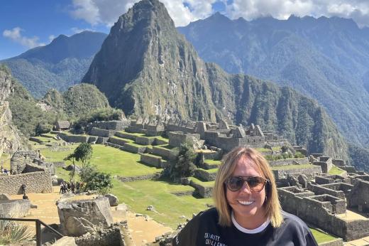 Female trekker smiling in front of mountains