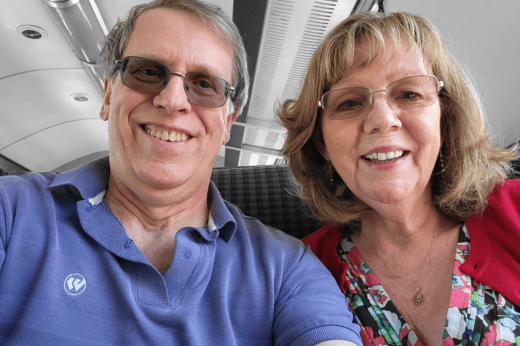 A selfie of a man and woman. Both are smiling.