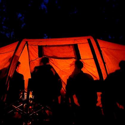 People in tent at night