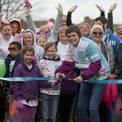 Joanne Jones cutting the ribbon at the start of the Marsden March