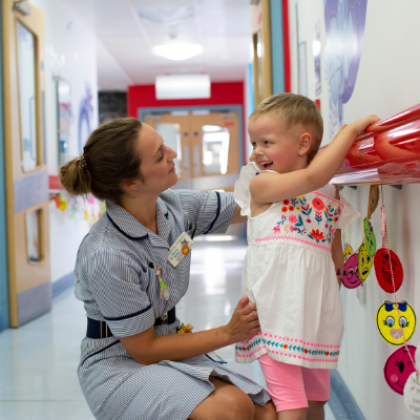 Nurse in hall with a child patient