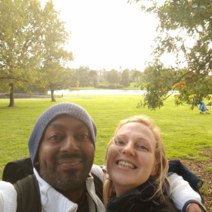 Image of smiley Ian hugging his wife Zoe
