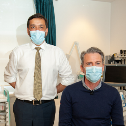 Patient wearing a mask with his doctor