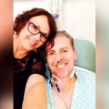 Patient, Mark, smiling in hospital with his wife