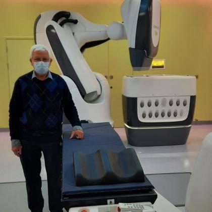 Patient standing next to imaging machine