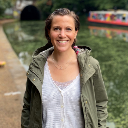 Katie Wilkins, standing by a canal, smiling at the camera