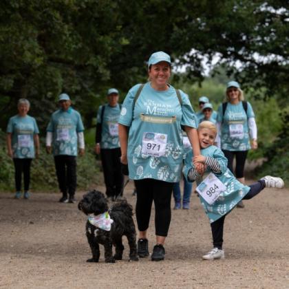 Family and a dog walking in the Banham Marsden March