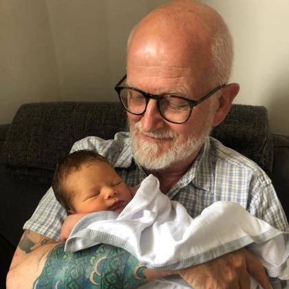 Dheeresh holding his grandson